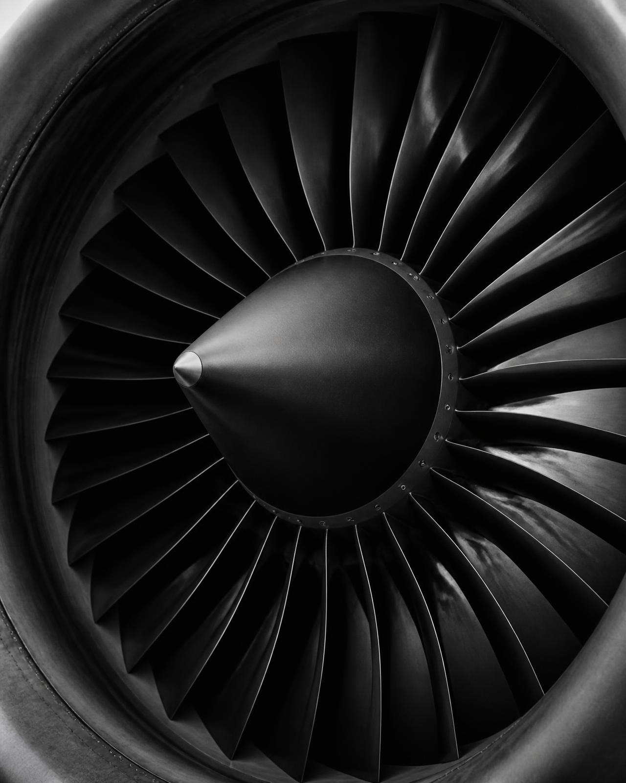 Monochrome close-up of a civil aviation turbofan engine fan